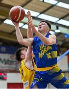 9 January 2022; Ronan Byrne of UCD Marian in action against Callum Russell of Killorglin CYMS during the Basketball Ireland Men's U20 Cup semi-final match between UCD Marian and Killorglin CYMS at Neptune Stadium in Cork. Photo by Brendan Moran/Sportsfile
