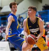 9 January 2022; Ruairi Murphy of Killorglin CYMS in action against Colm O'Reilly of UCD Marian during the Basketball Ireland Men's U20 Cup semi-final match between UCD Marian and Killorglin CYMS at Neptune Stadium in Cork. Photo by Brendan Moran/Sportsfile