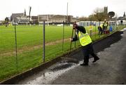 9 January 2022; Steward Tommy Kilchreest lays black pellets in damp areas before the Walsh Cup Senior Hurling round 1 match between Galway and Offaly at Duggan Park in Ballinasloe, Galway. Photo by Harry Murphy/Sportsfile