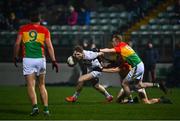 13 January 2022; Daniel Flynn of Kildare is tackled by Keegan Bradley and Conor Doyle of Carlow during the O'Byrne Cup Group C match between Carlow and Kildare at Netwatch Cullen Park in Carlow. Photo by Eóin Noonan/Sportsfile