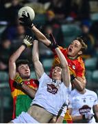 13 January 2022; Daniel Flynn of Kildare contests a high ball against Keegan Bradley, right, and Liam Brennan of Carlow during the O'Byrne Cup Group C match between Carlow and Kildare at Netwatch Cullen Park in Carlow. Photo by Eóin Noonan/Sportsfile