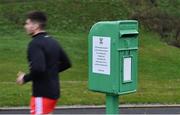 15 January 2022; A Derry player runs past a post box, used for Roslea GAA fundraising, as they make their way to warm-up before the Dr McKenna Cup round 3 match between Fermanagh and Derry at Shamrock Park in Roslea, Fermanagh. Photo by Piaras Ó Mídheach/Sportsfile