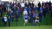 16 January 2022; Paddy Purcell of Laois races clear of Niall MacMahon of Kilkenny, under the watchful eyes of supporters on the bank, during the Walsh Cup Group B match between Kilkenny and Laois at John Lockes GAA Club in Callan, Kilkenny. Photo by Ray McManus/Sportsfile
