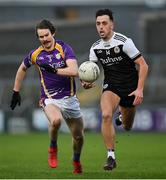 16 January 2022; Ryan Johnston of Kilcoo in action against Tiarnan Daly of Derrygonnelly Harps during the AIB Ulster GAA Football Club Senior Championship Final match between Derrygonnelly Harps and Kilcoo at the Athletic Grounds in Armagh. Photo by Ramsey Cardy/Sportsfile