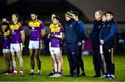 15 January 2022; Wexford backroom staff, including manager Shane Roche, right, stand for a moment of silence for the late Ashling Murphy before the O'Byrne Cup Group B match between Meath and Wexford at Ashbourne GAA Club in Ashbourne, Meath. Photo by Ben McShane/Sportsfile