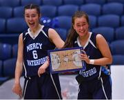 19 January 2022; Illana Fitzgerald of Our Lady of Mercy holds a sign aloft on behalf of her team-mate Sarah Hickey, left, after their side's victory in the Pinergy Basketball Ireland U19 A Girls Schools Cup Final match between Loreto Abbey Dalkey, Dublin, and Our Lady of Mercy, Waterford, at the National Basketball Arena in Dublin. Photo by Piaras Ó Mídheach/Sportsfile