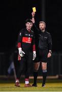19 January 2022; Dylan Foley of UCC is shown a yellow card by referee Anthony Nolan during the Electric Ireland Higher Education GAA Sigerson Cup Round 2 match between University College Dublin and University College Cork at UCD Billings Park in Dublin. Photo by Stephen McCarthy/Sportsfile