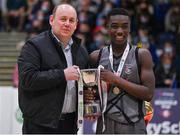 20 January 2022; Crescent Comprehensive captain Denis Mathews is presented the trophy by Basketball Ireland president PJ Reidy during the Pinergy Basketball Ireland U16 B Boys Schools Cup Final match between St Louis CS, Kiltimagh, Mayo and Crescent Comprehensive, Limerick, at the National Basketball Arena in Dublin. Photo by Harry Murphy/Sportsfile