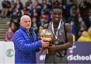 20 January 2022; MVP Denis Mathews of Crescent Comprehensive is presented his trophy by Ger Tarrant after the Pinergy Basketball Ireland U16 B Boys Schools Cup Final match between St Louis CS, Kiltimagh, Mayo and Crescent Comprehensive, Limerick, at the National Basketball Arena in Dublin. Photo by Harry Murphy/Sportsfile