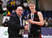 20 January 2022; Pobailscoil Chorca Dhuibhne captain Aivaras Uosis is presented the trophy by Basketball Ireland president PJ Reidy during the Pinergy Basketball Ireland U19 C Boys Schools Cup Final match between Gaelcholaiste Cheatharlach, Carlow, and Pobailscoil Chorca Dhuibhne, Dingle, Kerry, at the National Basketball Arena in Dublin. Photo by Harry Murphy/Sportsfile