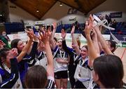 20 January 2022; OLSPCK players celebrate with the trophy after their side's victory in the Pinergy Basketball Ireland U16 B Girls Schools Cup Final match between OLSPCK, Belfast, and Colaiste Muire Crosshaven, Cork, at the National Basketball Arena in Dublin. Photo by Harry Murphy/Sportsfile