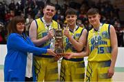 21 January 2022; UCD Marian co-captains, from left, Luke Gilleran, Brian O'Hara Duggan and Paraic Moran are presented with the cup by secretary of the NABC of Baeketball Ireland Margaret Miley after during the InsureMyHouse.ie U20 Men's National Cup Final match between UCC Blue Demons, Cork and UCD Marian, Dublin at the National Basketball Arena in Tallaght, Dublin. Photo by Brendan Moran/Sportsfile