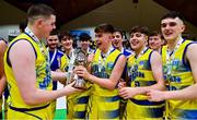 21 January 2022; Paraic Moran of UCD Marian, centre, celebrates with teammate Luke Gilleran, left, and the cup after  the InsureMyHouse.ie U20 Men's National Cup Final match between UCC Blue Demons, Cork and UCD Marian, Dublin at the National Basketball Arena in Tallaght, Dublin. Photo by Brendan Moran/Sportsfile