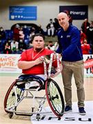 22 January 2022; Rebel Wheelers captain Jack Quinn is presented with the cup by director of sport at the Irish Wheelchair Association Nicky Hamill after the InsureMyHouse.ie IWA Cup final match between Killester BC, Dublin, and Rebel Wheelers, Cork, at National Basketball Arena in Tallaght, Dublin. Photo by Brendan Moran/Sportsfile