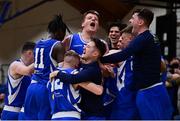 22 January 2022; UCC Demons players, including Conor Ryan, celebrate at the final buzzer of the InsureMyHouse.ie Presidents' National Cup Final match between UCC Demons, Cork, and Drogheda Wolves, Louth, at National Basketball Arena in Tallaght, Dublin. Photo by Brendan Moran/Sportsfile