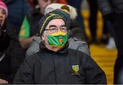 22 January 2022; A Donegal fan with a face mask on watches on during the Dr McKenna Cup Final match between Donegal and Monaghan at O'Neill's Healy Park in Omagh, Tyrone. Photo by Oliver McVeigh/Sportsfile