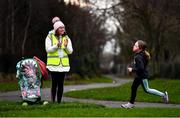 23 January 2022; Parkrun Ireland in partnership with Vhi, expanded their range of junior events to 24 with the introduction of the Mellowes junior parkrun in Dublin on Sunday morning. Junior parkruns are 2km long and cater for 4 to 14-year olds, free of charge providing a fun and safe environment for children to enjoy exercise. To register for a parkrun near you visit www.parkrun.ie. Pictured is volunteer Suzie Keller, with her son Liam, encouraging the participants during the parkrun. Photo by Ben McShane/Sportsfile