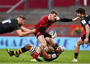 23 January 2022; Chris Farrell of Munster is tackled by Nizaam Carr, centre, and Elliott Stooke, right, both of Wasps, during the Heineken Champions Cup Pool B match between Munster and Wasps at Thomond Park in Limerick. Photo by Sam Barnes/Sportsfile