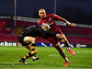 23 January 2022; Simon Zebo of Munster evades the tackle of Ali Crossdale of Wasps on his way to scoring his side's fifth try during the Heineken Champions Cup Pool B match between Munster and Wasps at Thomond Park in Limerick. Photo by Sam Barnes/Sportsfile