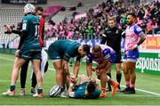 23 January 2022; Caolin Blade of Connacht, centre, is helped up from the floor by teammate Conor Oliver, left, and Clement Castets of Stade Francais Paris after scoring his side's second try during the Heineken Champions Cup Pool A match between Stade Francais Paris and Connacht at Stade Jean Bouin in Paris, France. Photo by Seb Daly/Sportsfile