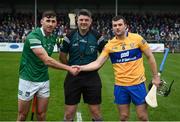 23 January 2022; The Limerick, Barry Nash, and Clare, Jack Browne, captains shake hands across referee Conor Doyle before the 2022 Co-op Superstores Munster Hurling Cup Final match between Limerick and Clare at Cusack Park in Ennis, Clare. Photo by Ray McManus/Sportsfile