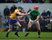 23 January 2022; Colin Coughlan of Limerick is tackled by Patrick Crotty of Clare during the 2022 Co-op Superstores Munster Hurling Cup Final match between Limerick and Clare at Cusack Park in Ennis, Clare. Photo by Ray McManus/Sportsfile
