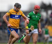 23 January 2022; Cathal Malone of Clare races clear on Colin Coughlan of Limerick during the 2022 Co-op Superstores Munster Hurling Cup Final match between Limerick and Clare at Cusack Park in Ennis, Clare. Photo by Ray McManus/Sportsfile