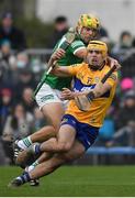 23 January 2022; Mark Rodgers of Clare is tackled by Dan Morrissey of Limerick during the 2022 Co-op Superstores Munster Hurling Cup Final match between Limerick and Clare at Cusack Park in Ennis, Clare. Photo by Ray McManus/Sportsfile
