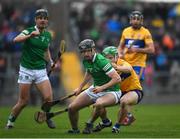 23 January 2022; Ronan Connolly of Limerick is tackled by Domhnall McManon of Clare during the 2022 Co-op Superstores Munster Hurling Cup Final match between Limerick and Clare at Cusack Park in Ennis, Clare. Photo by Ray McManus/Sportsfile