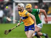 23 January 2022; Ryan Taylor of Clare is tackled by Cathal O’Neill of Limerick during the 2022 Co-op Superstores Munster Hurling Cup Final match between Limerick and Clare at Cusack Park in Ennis, Clare. Photo by Ray McManus/Sportsfile