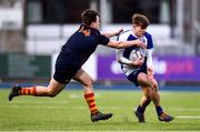 26 January 2022; James Light of St Andrews College is tackled by Rhys Gamble of Temple Carrig during the Bank of Ireland Vinnie Murray Cup 1st Round match between Temple Carrig, Wicklow and St Andrews College, Dublin at Energia Park in Dublin. Photo by Ben McShane/Sportsfile