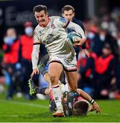 28 January 2022; Billy Burns of Ulster evades the tackle of Tyler Morgan of Scarlets during the United Rugby Championship match between Ulster and Scarlets at the Kingspan Stadium in Belfast. Photo by Ramsey Cardy/Sportsfile