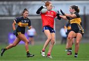 29 January 2022; Olivia Divilly of Kilkerrin-Clonberne in action against Mourneabbey players Niamh O'Sullivan, right, and Molly Burke during the 2021 currentaccount.ie All-Ireland Ladies Senior Club Football Championship Final match between Mourneabbey and Kilkerrin-Clonberne at St Brendan's Park in Birr, Offaly. Photo by Piaras Ó Mídheach/Sportsfile