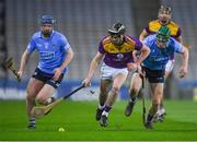 29 January 2022; Connal Flood of Wexford in action against Conor Burke, left, and James Madden of Dublin during the Walsh Cup Final match between Dublin and Wexford at Croke Park in Dublin. Photo by Ray McManus/Sportsfile