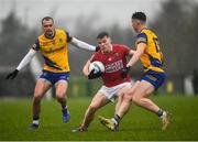30 January 2022; John Cooper of Cork in action against Cian McKeon, right, and Enda Smith of Roscommon during the Allianz Football League Division 2 match between Roscommon and Cork at Dr Hyde Park in Roscommon. Photo by David Fitzgerald/Sportsfile