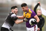 30 January 2022; Glen Malone of Wexford in action against Nathan Mullen of Sligo during the Allianz Football League Division 4 match between Wexford and Sligo at Chadwicks Wexford Park in Wexford. Photo by Matt Browne/Sportsfile