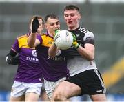 30 January 2022; Alan Reilly of Sligo in action against Dylan Furlong of Wexford during the Allianz Football League Division 4 match between Wexford and Sligo at Chadwicks Wexford Park in Wexford. Photo by Matt Browne/Sportsfile