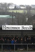 30 January 2022; Supporters shelter underneath a Roscommon Herald sign during the Allianz Football League Division 2 match between Roscommon and Cork at Dr Hyde Park in Roscommon. Photo by David Fitzgerald/Sportsfile