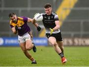 30 January 2022; Alan Reilly of Sligo in action against Dylan Furlong of Wexford during the Allianz Football League Division 4 match between Wexford and Sligo at Chadwicks Wexford Park in Wexford.Sligo at Chadwicks Wexford Park in Wexford. Photo by Matt Browne/Sportsfile