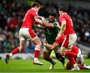 5 February 2022; Bundee Aki of Ireland is tackled by Wales players, from left, Nick Tompkins, Dan Biggar and Taine Basham during the Guinness Six Nations Rugby Championship match between Ireland and Wales at the Aviva Stadium in Dublin. Photo by David Fitzgerald/Sportsfile
