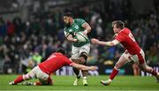 5 February 2022; Bundee Aki of Ireland offloads in the tackle from Taine Basham, left, and Nick Tompkins of Wales during the Guinness Six Nations Rugby Championship match between Ireland and Wales at Aviva Stadium in Dublin. Photo by Brendan Moran/Sportsfile