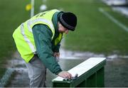 6 February 2022; Steward John Mongey wipes down the team photo bench before the Allianz Football League Division 2 match between Meath and Roscommon at Páirc Táilteann in Navan, Meath. Photo by Harry Murphy/Sportsfile
