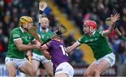 6 February 2022; Mikie Dwyer of Wexford is tackled by Dan Morrissey, left, and Simon Barry Nash of Limerick on his way to scoring a goal, in the 23rd minute of the second half, during the Allianz Hurling League Division 1 Group A match between Wexford and Limerick at Chadwicks Wexford Park in Wexford. Photo by Ray McManus/Sportsfile