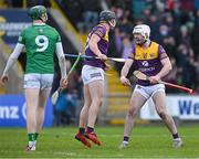6 February 2022; William O’Donoghue of Limerick looks on as Mikie Dwyer of Wexford celebrates with team mate Oisín Foley after scoring a goal, in the 23rd minute of the second half, during the Allianz Hurling League Division 1 Group A match between Wexford and Limerick at Chadwicks Wexford Park in Wexford. Photo by Ray McManus/Sportsfile