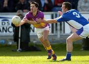 4 April 2004; John Hegarty, Wexford, in action against Colm Byrne, Laois. Allianz Football League, Division 1B, Round 7, Laois v Wexford, O'Moore Park, Portlaoise, Co. Laois. Picture credit; Damien Eagers / SPORTSFILE *EDI*
