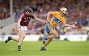 28 July 2013; Conor McGrath, Clare, on his way to scoring his side's first goal despite the efforts of Kevin Hynes, Galway. GAA Hurling All-Ireland Senior Championship, Quarter-Final, Galway v Clare, Semple Stadium, Thurles, Co. Tipperary. Picture credit: Stephen McCarthy / SPORTSFILE