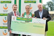 28 July 2013; Professor Ciarán Ó Catháin, left, President of Athletics Ireland, and Ray Colman, right, Chief Executive of Woodie's DIY and Garden Centres, present a cheque to Athlete of the Meet, Kelly Proper, Ferrybank A.C., Co. Waterford, with her four gold medals that she won in the the Women's 100m, 200m, Long Jump and 4x100 Team Relay events at the Woodie’s DIY National Senior Track and Field Championships. Morton Stadium, Santry, Co. Dublin. Picture credit: Tomas Greally / SPORTSFILE