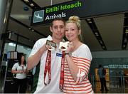 28 July 2013; The Irish squad, sponsored by Allianz, return from the 2013 IPC Athletics World Championships in Lyon, France, having secured a total of four gold medals and one silver medal. Pictured is Jason Smyth, left, Eglinton, Co. Derry, gold medals in the Men’s 100m – T13 and Men’s 200m – T13, and his wife Elise. Dublin Airport, Dublin. Picture credit: Matt Browne / SPORTSFILE
