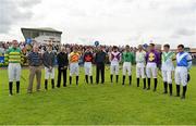 30 July 2013; Jockeys stand for a minute's silence in memory of TV presenter Colm Murray, before the Topaz Novice Hurdle. Galway Racing Festival, Ballybrit, Co. Galway. Picture credit: Barry Cregg / SPORTSFILE