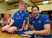 31 July 2013; Leinster's Kevin McLaughlin signs a jersey for Hugo Owens, age 8, from the Curragh Camp, during a Leinster Rugby Summer Camp at Cill Dara RFC, Kildare, Co. Kildare. Picture credit: David Maher / SPORTSFILE